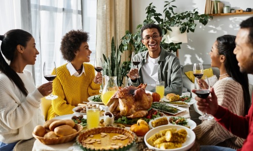 Friends gathering around a dinner table for a feast